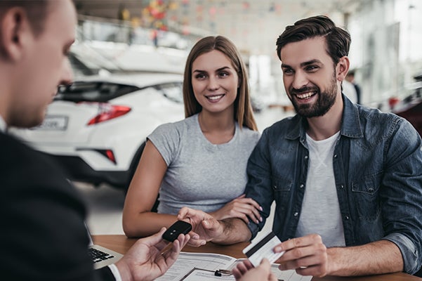 couple signing for car